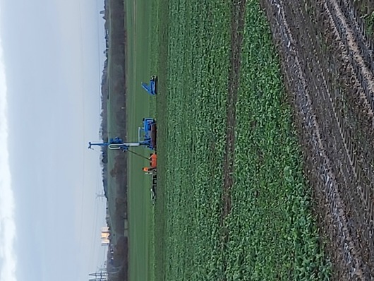 Bohrgeraet und Raupentransporter auf einem Feld